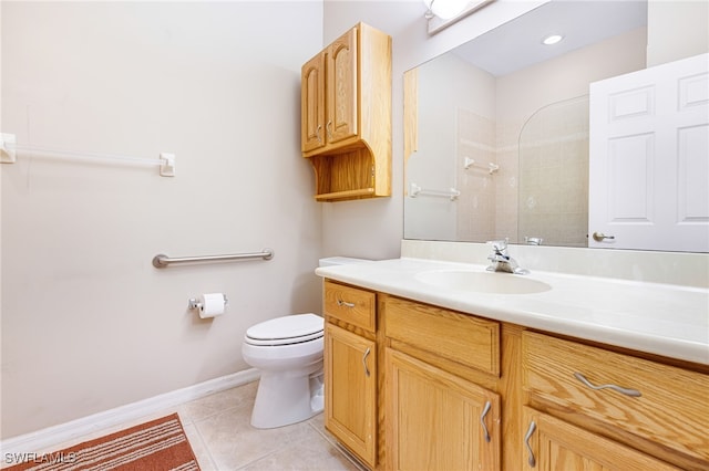 bathroom featuring tiled shower, tile patterned flooring, vanity, and toilet