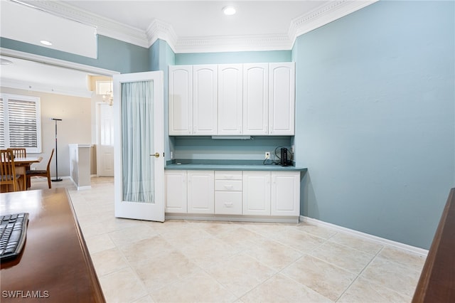 kitchen featuring crown molding, white cabinets, and light tile patterned flooring