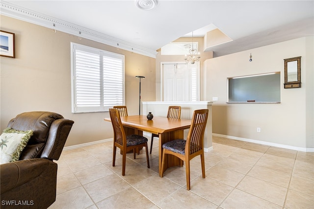 dining area featuring ornamental molding, light tile patterned floors, and a chandelier