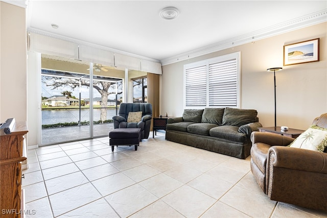 living room featuring light tile patterned floors, a water view, ceiling fan, and ornamental molding