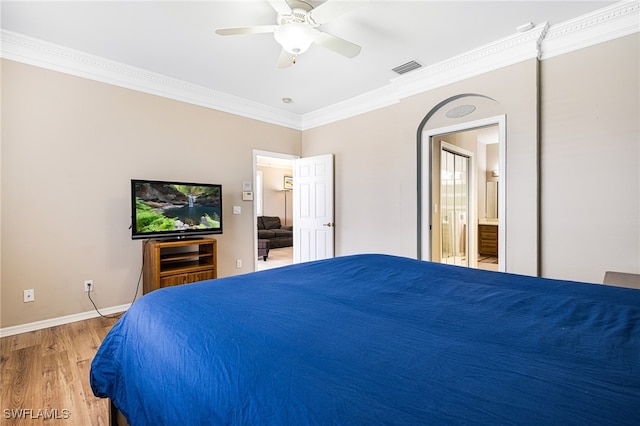 bedroom with hardwood / wood-style flooring, ceiling fan, ornamental molding, and ensuite bathroom