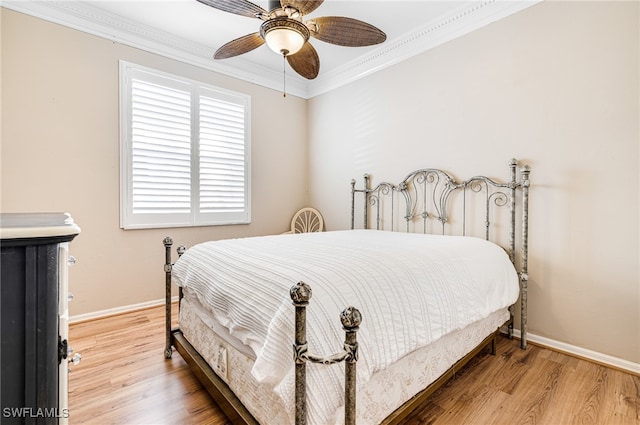 bedroom featuring hardwood / wood-style floors, ceiling fan, and ornamental molding