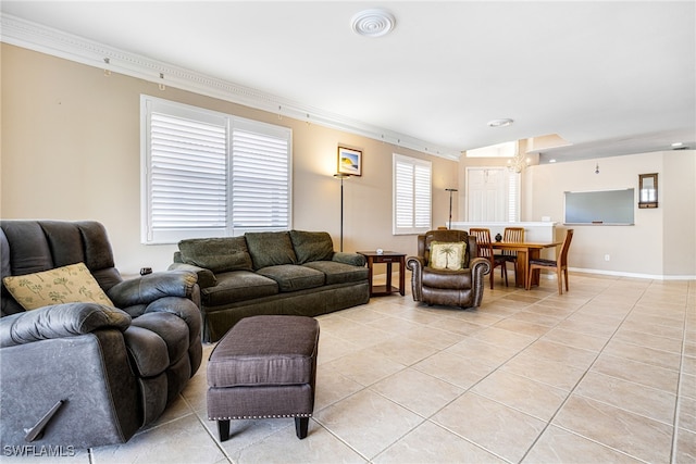 living room with a chandelier, crown molding, and light tile patterned flooring