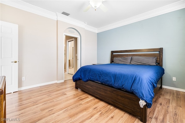 bedroom with ceiling fan, crown molding, and light wood-type flooring