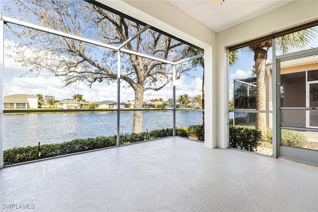 unfurnished sunroom featuring a water view