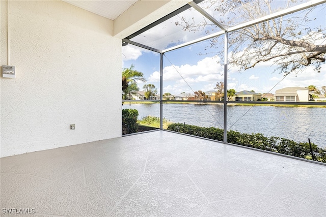 unfurnished sunroom with a water view