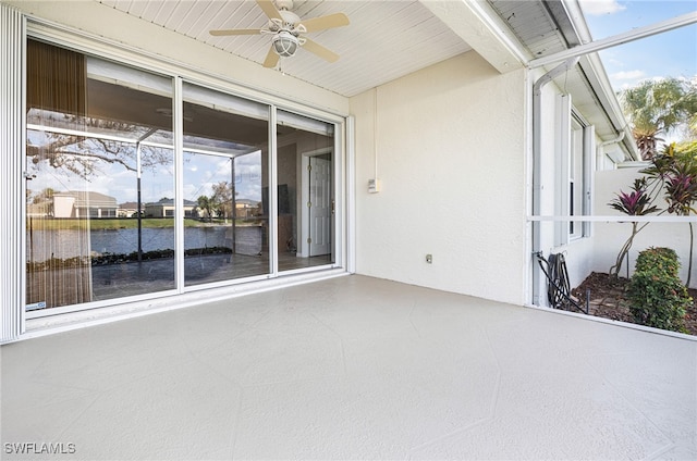 view of patio / terrace with ceiling fan and a water view