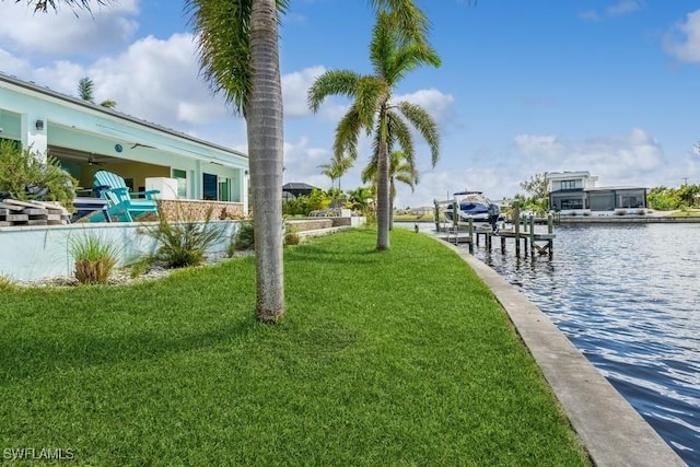 exterior space with a water view and a lawn