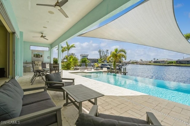 view of pool with area for grilling, an outdoor living space, ceiling fan, a water view, and a patio