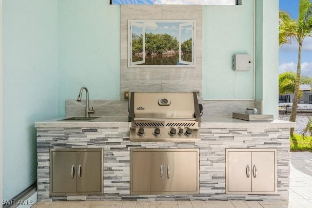 view of patio / terrace featuring an outdoor kitchen, sink, and grilling area