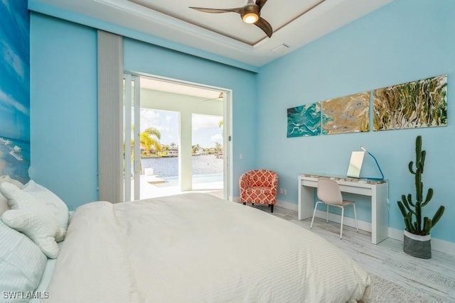 bedroom featuring hardwood / wood-style floors, ceiling fan, and access to exterior