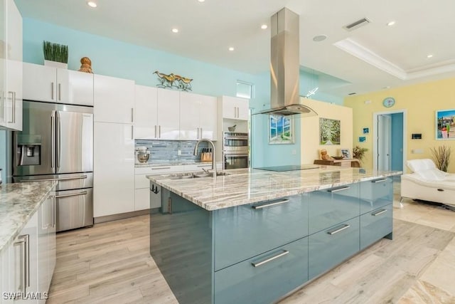 kitchen featuring white cabinetry, a large island with sink, and appliances with stainless steel finishes