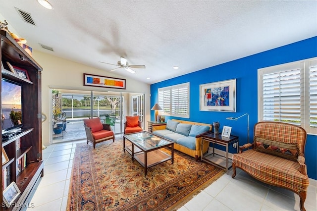 living room with light tile patterned floors, plenty of natural light, and lofted ceiling