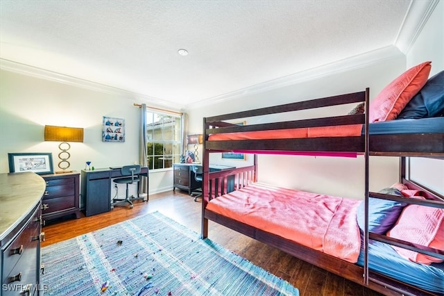 bedroom featuring ornamental molding, a textured ceiling, and hardwood / wood-style flooring