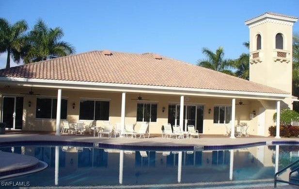 rear view of house featuring a patio area, ceiling fan, and a community pool