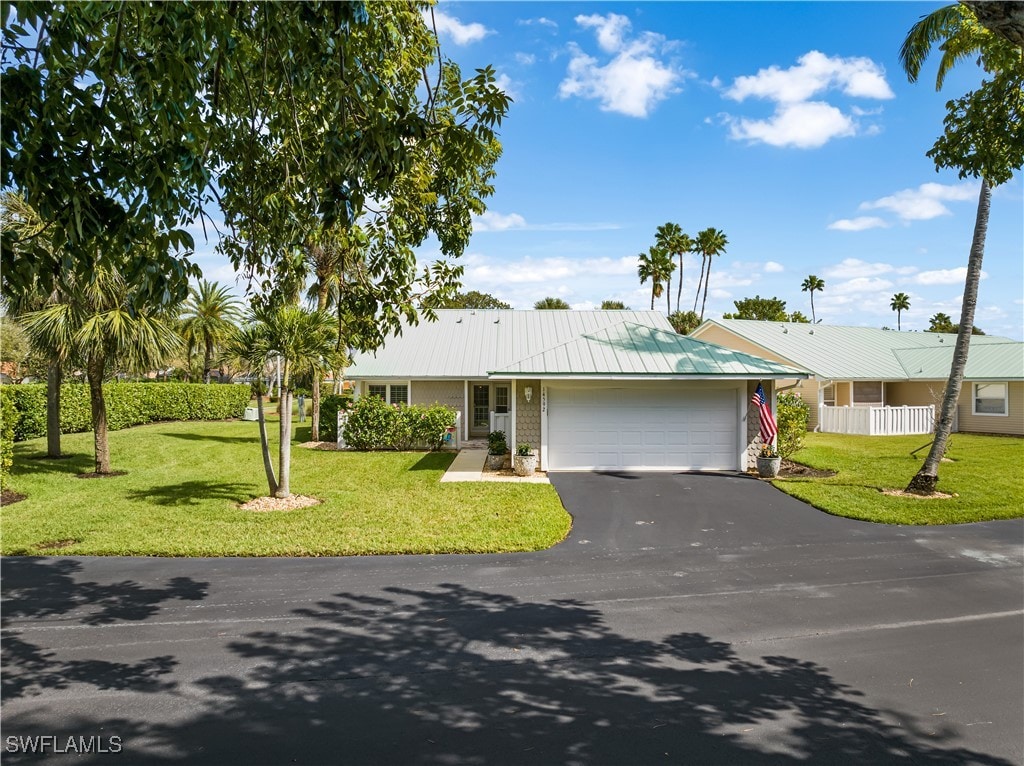 ranch-style house with a front yard and a garage