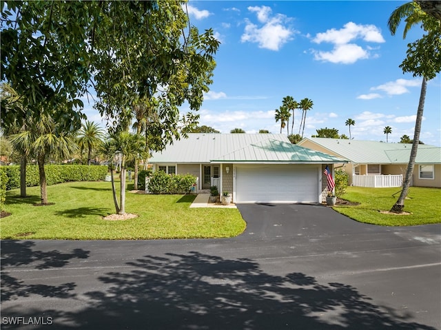 ranch-style house with a front yard and a garage