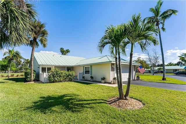 ranch-style home with a front lawn and a garage