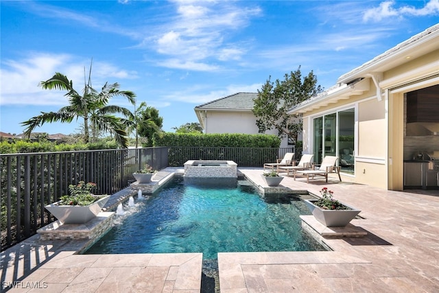 view of swimming pool featuring pool water feature, a patio area, and an in ground hot tub