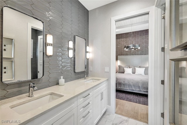 bathroom with hardwood / wood-style flooring, vanity, and decorative backsplash