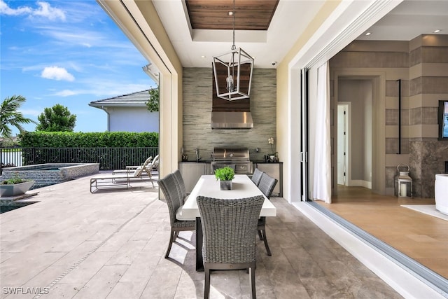 view of patio / terrace featuring an in ground hot tub, sink, area for grilling, and exterior kitchen