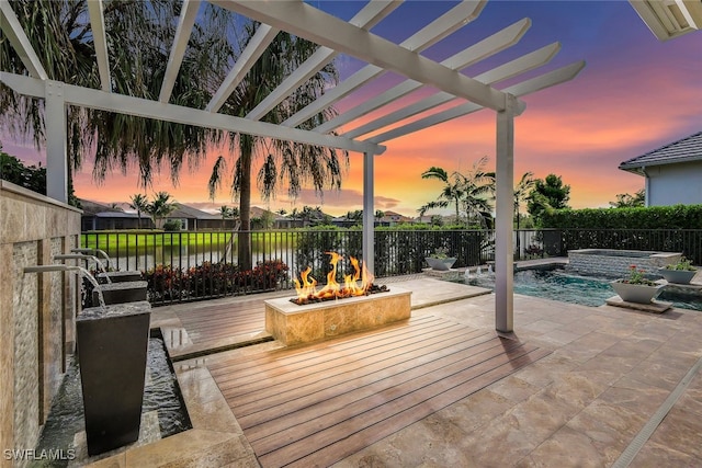 patio terrace at dusk featuring a swimming pool with hot tub, a pergola, and pool water feature