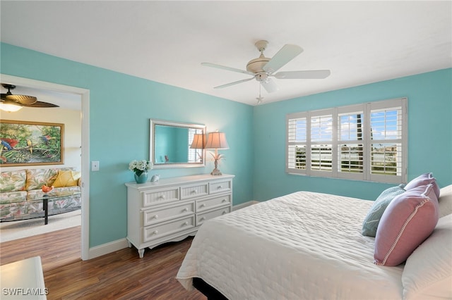 bedroom featuring ceiling fan and dark hardwood / wood-style flooring