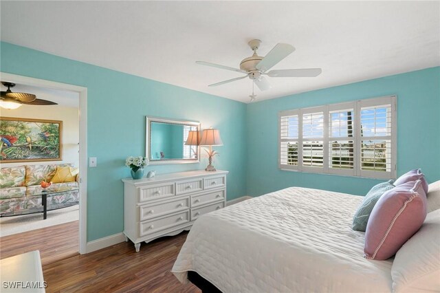 730 W Elkcam Cir Unit 205, Marco Island, FL 34145 - bedroom with wood finished floors, baseboards, and a ceiling fan