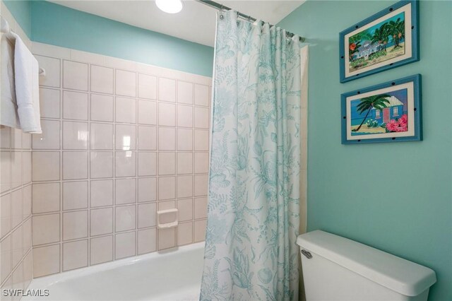 730 W Elkcam Cir Unit 205, Marco Island, FL 34145 - bathroom featuring shower / bath combination with curtain and toilet