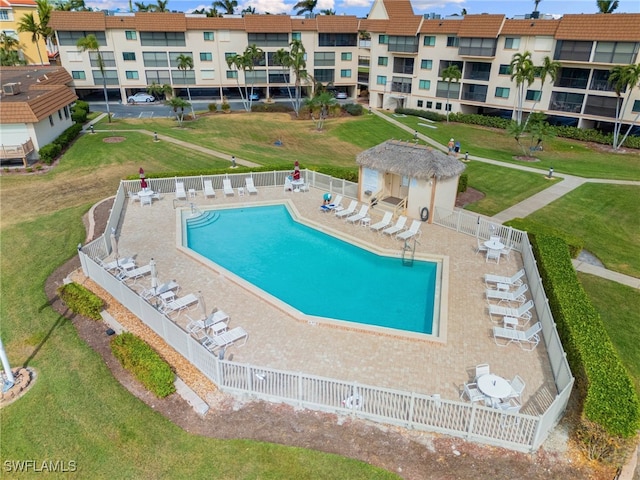 view of swimming pool featuring a patio and a yard