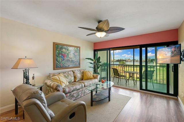 living room with wood-type flooring and ceiling fan