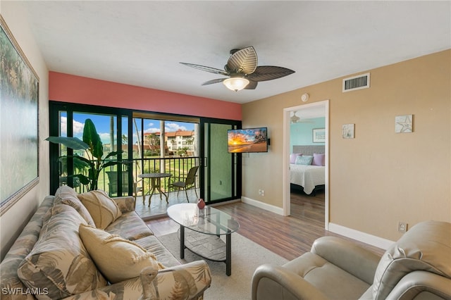 living room with hardwood / wood-style flooring and ceiling fan