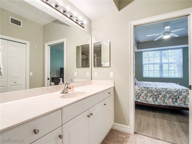 bathroom featuring hardwood / wood-style floors, vanity, and ceiling fan