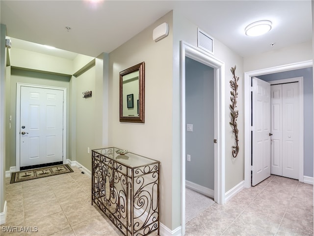 hallway featuring light tile patterned flooring