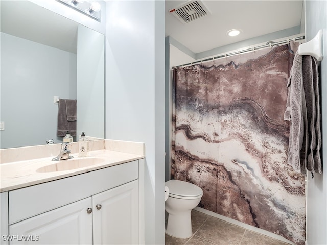 bathroom featuring tile patterned flooring, vanity, and toilet