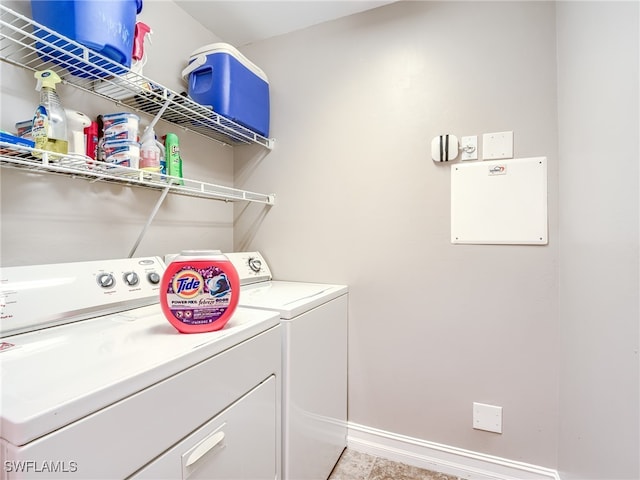 clothes washing area with separate washer and dryer and light tile patterned floors