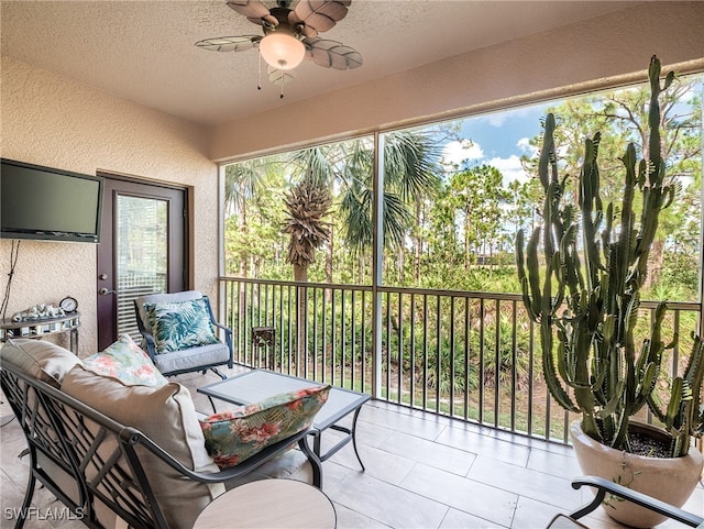 sunroom featuring ceiling fan