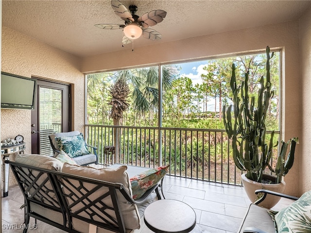 sunroom / solarium with ceiling fan and a healthy amount of sunlight