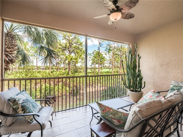 sunroom / solarium featuring ceiling fan