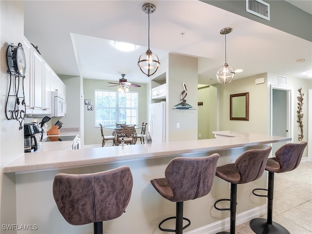 kitchen with white cabinetry, ceiling fan, hanging light fixtures, and white appliances