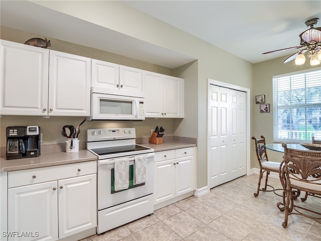 kitchen with ceiling fan, light tile patterned floors, white cabinets, and white appliances