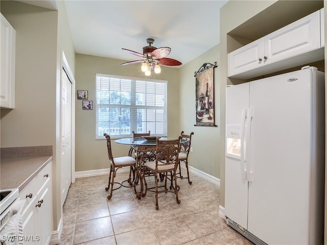 tiled dining room featuring ceiling fan