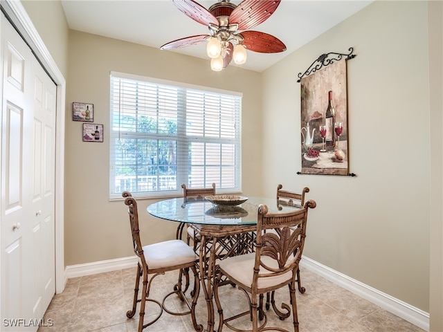 tiled dining space featuring ceiling fan