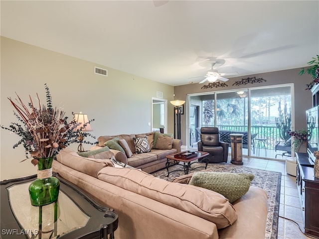 living room with ceiling fan and tile patterned flooring