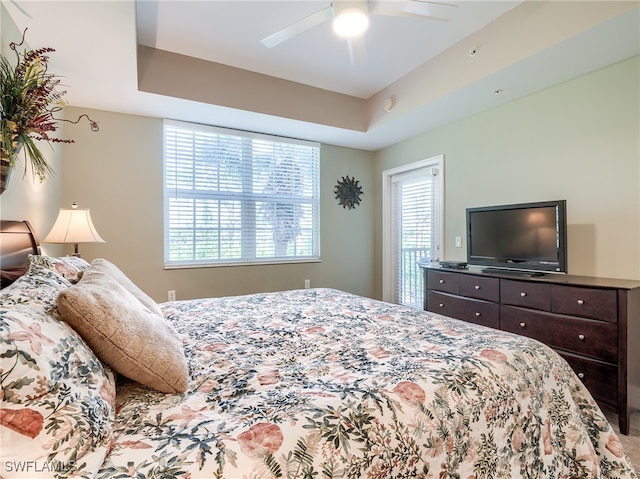 bedroom featuring ceiling fan and a raised ceiling