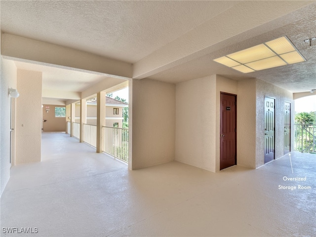 interior space with a textured ceiling and a healthy amount of sunlight