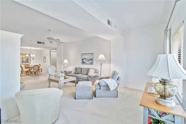 living room featuring light carpet and ceiling fan with notable chandelier