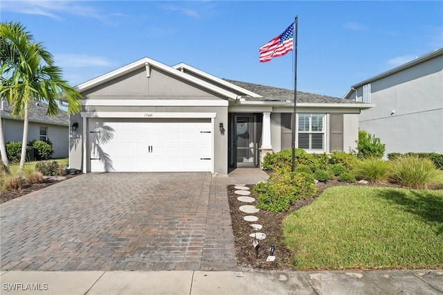 single story home featuring a garage and a front lawn