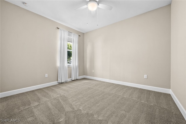 carpeted empty room with ceiling fan