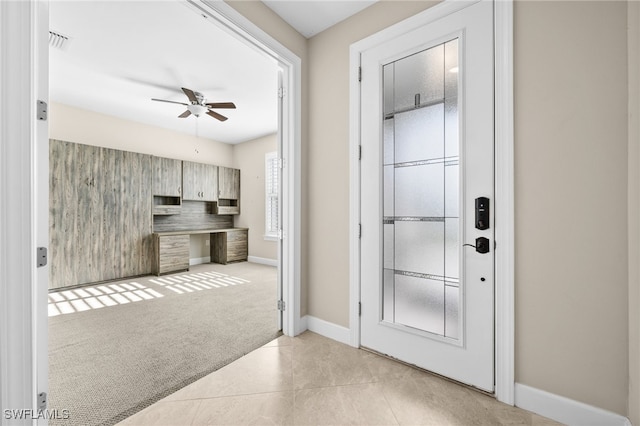 kitchen featuring ceiling fan and light colored carpet